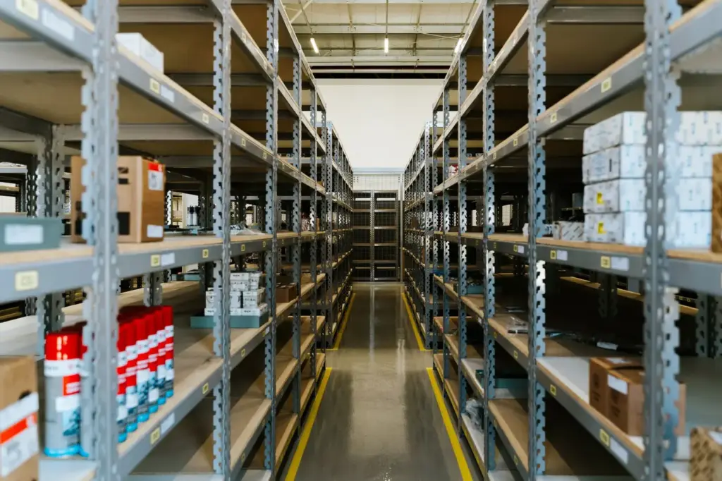 A long warehouse aisle lined with stocked shelving
