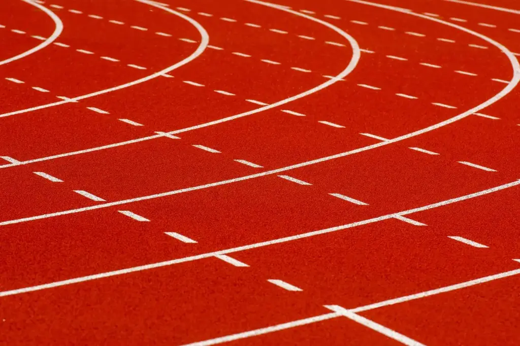 Curved white lane markings on a red athletics running track